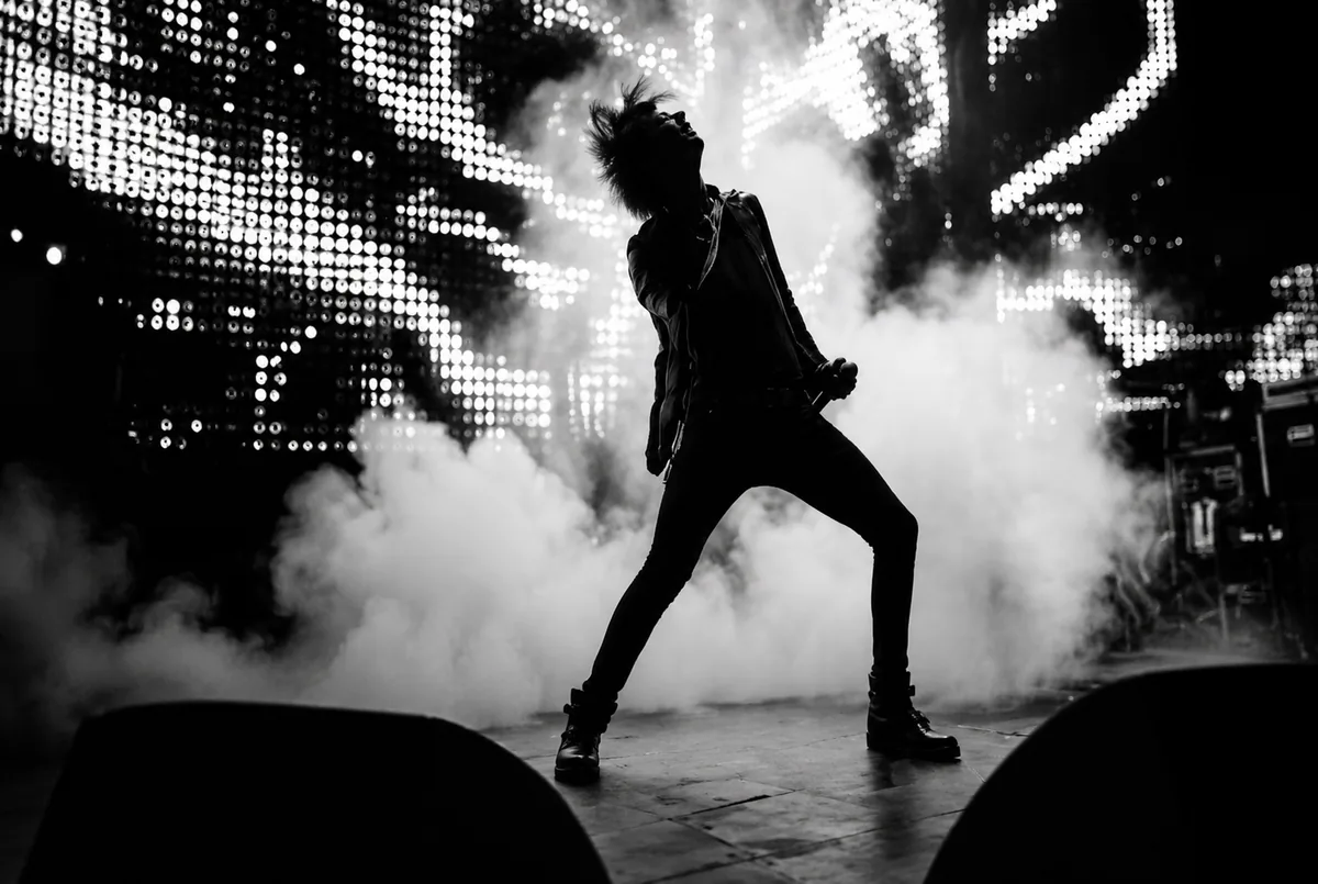 Performer on stage during a cinematic music video shoot
