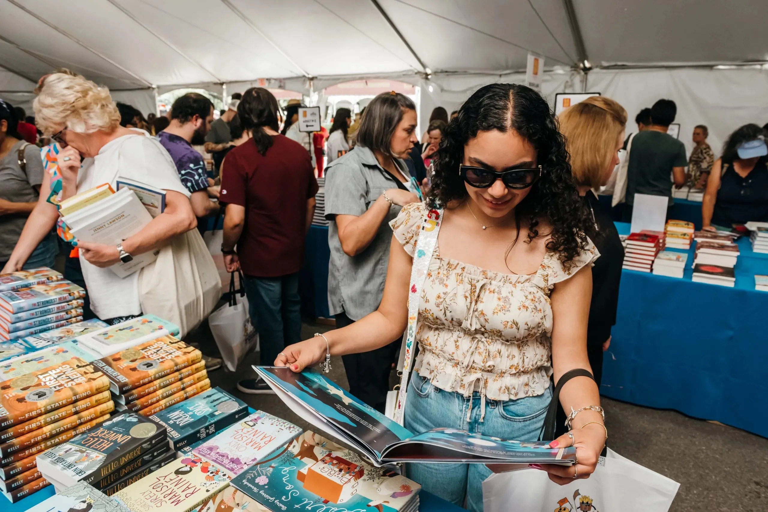 Reader discovering a book at a fair booth